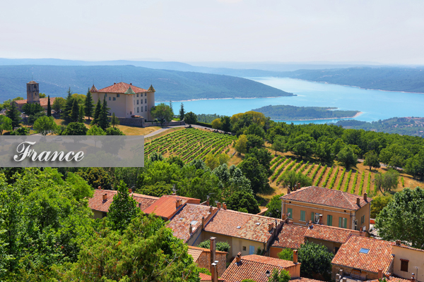chateau and church in Aiguines and St Croix Lake at background, France